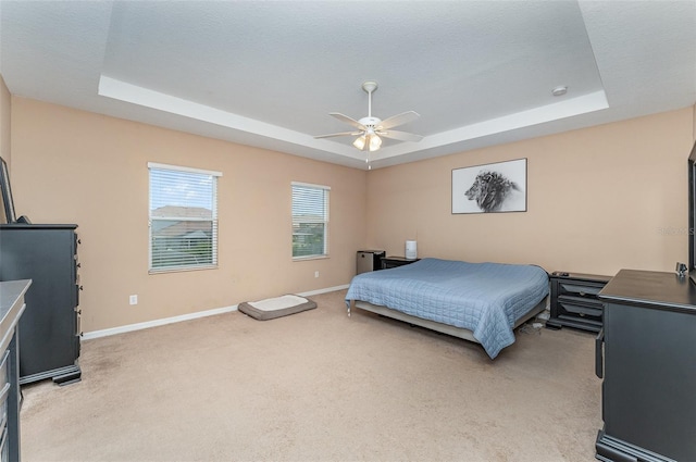 11206 Coventry Grove Cir, Lithia, FL 33547 - bedroom featuring a tray ceiling, light carpet, and baseboards