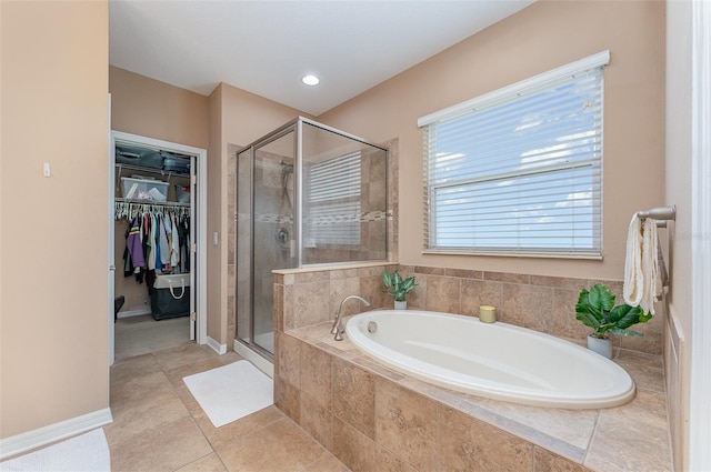 11206 Coventry Grove Cir, Lithia, FL 33547 - full bath with a bath, a stall shower, a spacious closet, and tile patterned floors