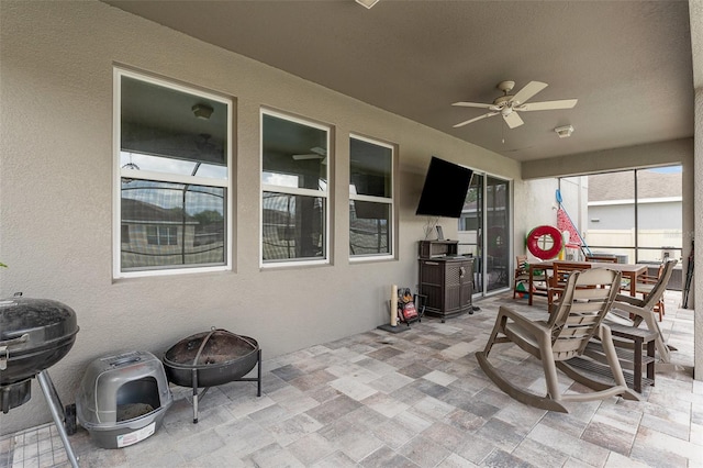 11206 Coventry Grove Cir, Lithia, FL 33547 - view of patio / terrace with a ceiling fan, a fire pit, and outdoor dining space