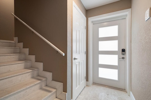 215 18th Ave, Indian Rocks Beach, FL 33785 - foyer featuring stairs, healthy amount of natural light, baseboards, and a textured wall