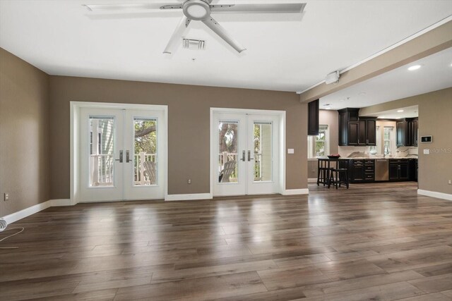 215 18th Ave, Indian Rocks Beach, FL 33785 - unfurnished living room featuring french doors, plenty of natural light, a ceiling fan, and recessed lighting