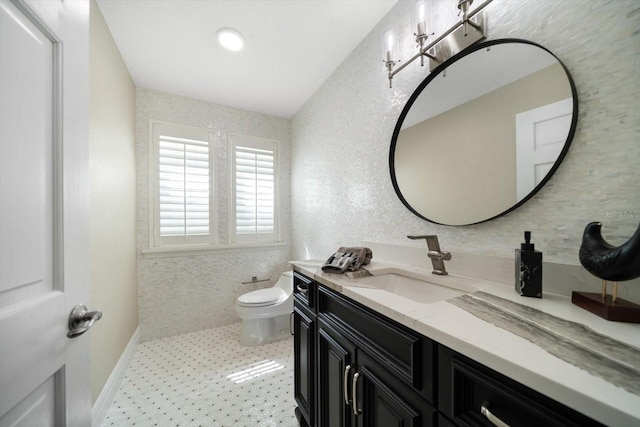 215 18th Ave, Indian Rocks Beach, FL 33785 - bathroom with vanity, toilet, and tile patterned floors