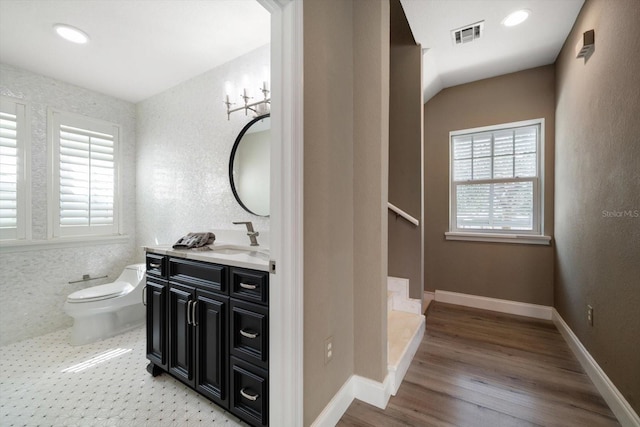 215 18th Ave, Indian Rocks Beach, FL 33785 - full bathroom featuring vanity, toilet, wood finished floors, baseboards, and a shower