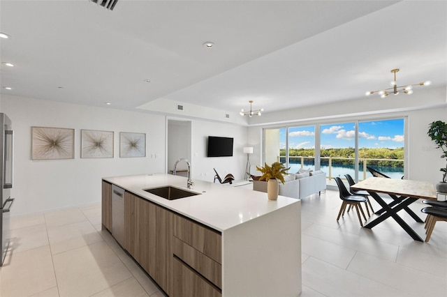 1020 Sunset Point Rd Unit 410, Clearwater, FL 33756 - kitchen featuring a sink, modern cabinets, a chandelier, open floor plan, and recessed lighting
