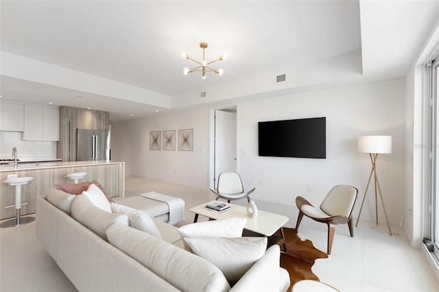 1020 Sunset Point Rd Unit 410, Clearwater, FL 33756 - living area with a chandelier, recessed lighting, and a tray ceiling