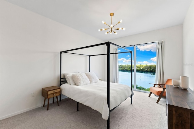 1020 Sunset Point Rd Unit 410, Clearwater, FL 33756 - bedroom with a chandelier, carpet flooring, baseboards, and a water view