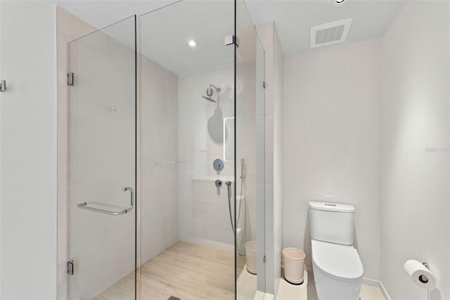 1020 Sunset Point Rd Unit 410, Clearwater, FL 33756 - full bathroom featuring toilet, a shower stall, and recessed lighting