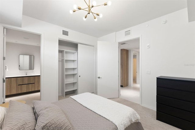 1020 Sunset Point Rd Unit 410, Clearwater, FL 33756 - bedroom with light carpet, a chandelier, a closet, and a sink