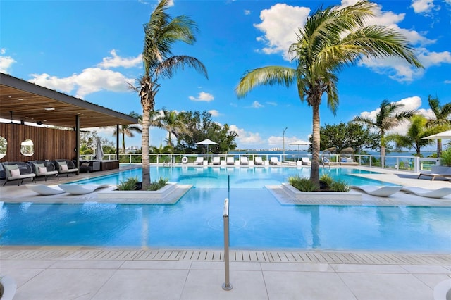 1020 Sunset Point Rd Unit 410, Clearwater, FL 33756 - community pool featuring a patio area and an outdoor living space