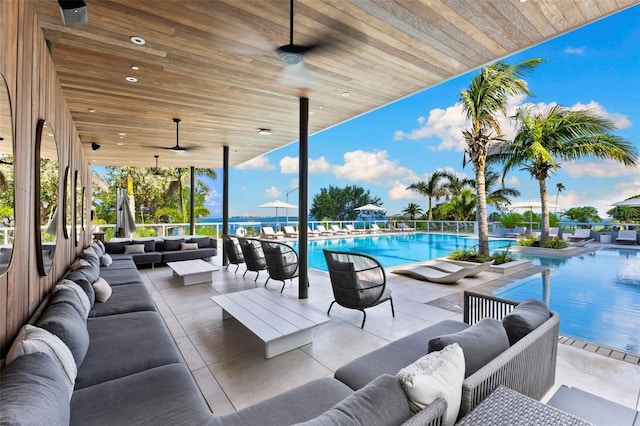 1020 Sunset Point Rd Unit 410, Clearwater, FL 33756 - view of patio / terrace featuring outdoor lounge area, a ceiling fan, and a community pool