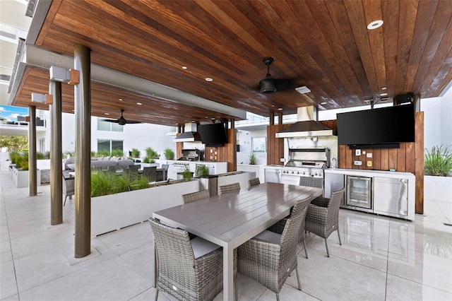 1020 Sunset Point Rd Unit 410, Clearwater, FL 33756 - view of patio featuring area for grilling, a ceiling fan, and outdoor dining space