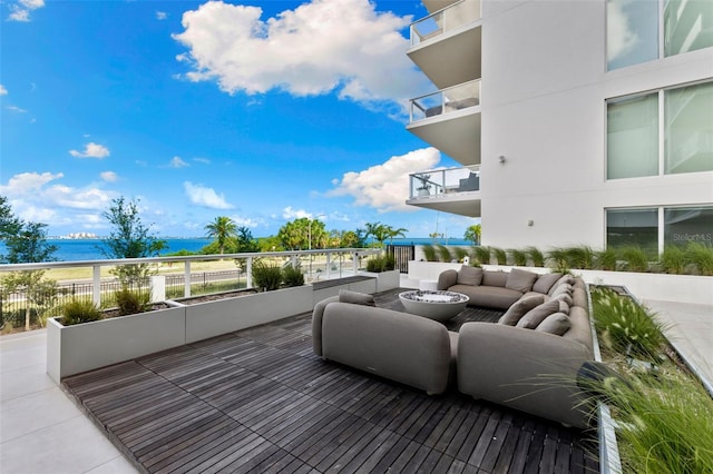 1020 Sunset Point Rd Unit 410, Clearwater, FL 33756 - wooden terrace featuring an outdoor living space and a water view