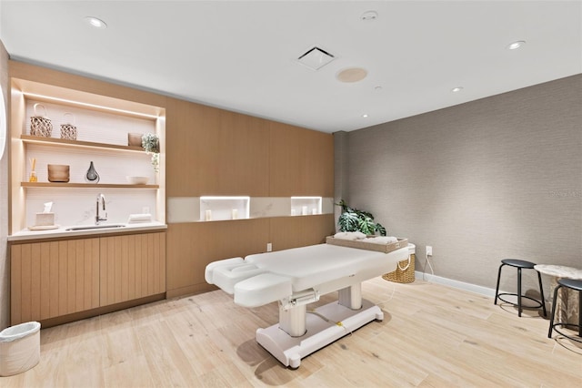 1020 Sunset Point Rd Unit 410, Clearwater, FL 33756 - rec room with a sink, light wood-type flooring, baseboards, recessed lighting, and wallpapered walls