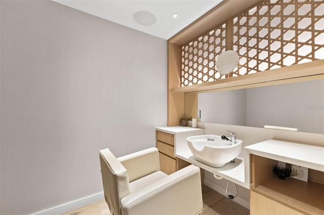 1020 Sunset Point Rd Unit 410, Clearwater, FL 33756 - bathroom with a sink, a bathtub, wood finished floors, and baseboards