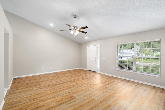 9721 Fredericksburg Rd, Tampa, FL 33635 - empty room with ceiling fan, light wood-style flooring, baseboards, vaulted ceiling, and recessed lighting