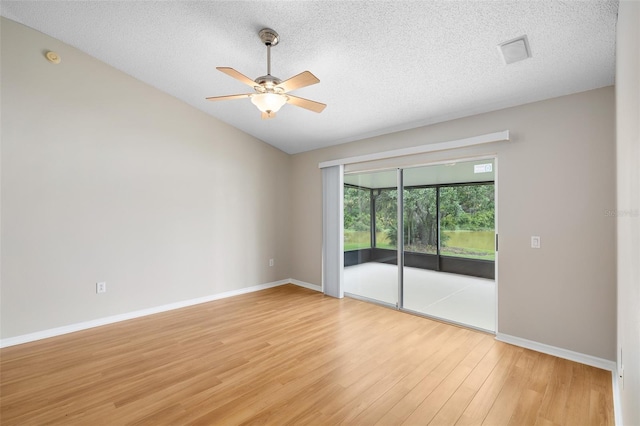 9721 Fredericksburg Rd, Tampa, FL 33635 - spare room with light wood-style floors, a ceiling fan, baseboards, a textured ceiling, and vaulted ceiling