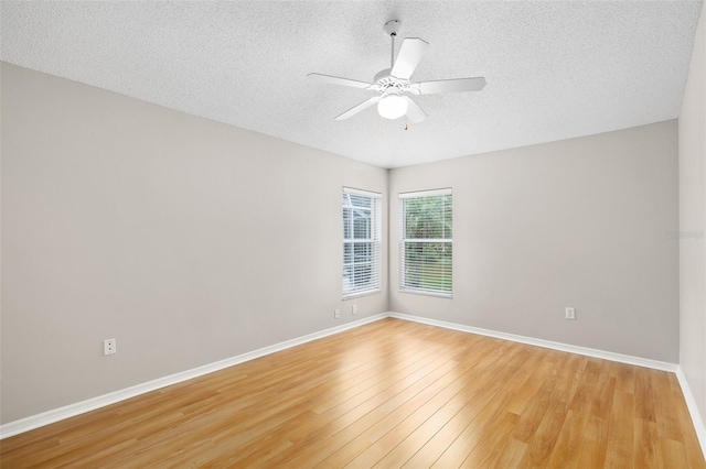 9721 Fredericksburg Rd, Tampa, FL 33635 - empty room with a textured ceiling, light wood finished floors, ceiling fan, and baseboards