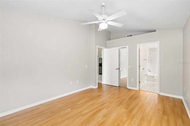 9721 Fredericksburg Rd, Tampa, FL 33635 - unfurnished bedroom with lofted ceiling, light wood-style flooring, baseboards, ensuite bathroom, and a ceiling fan