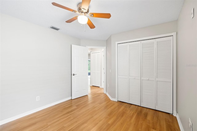 9721 Fredericksburg Rd, Tampa, FL 33635 - unfurnished bedroom with light wood-style floors, baseboards, a closet, and a ceiling fan