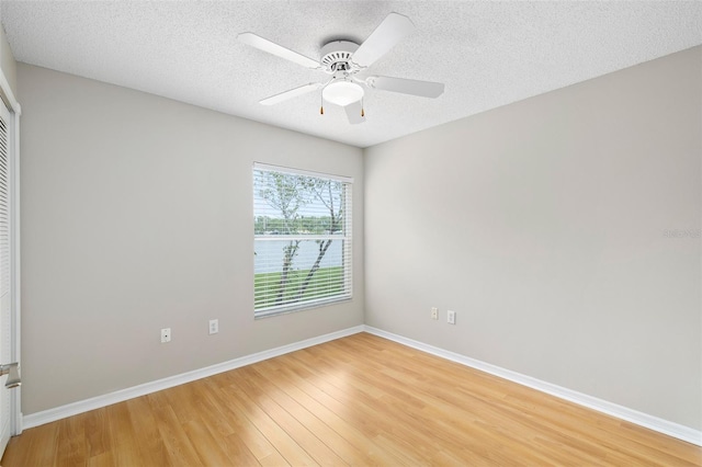 9721 Fredericksburg Rd, Tampa, FL 33635 - empty room featuring light wood-style floors, baseboards, a textured ceiling, and ceiling fan