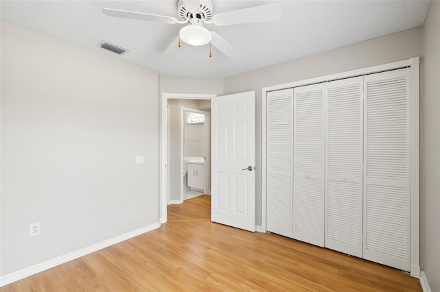 9721 Fredericksburg Rd, Tampa, FL 33635 - unfurnished bedroom featuring light wood-style floors, baseboards, a closet, and ceiling fan