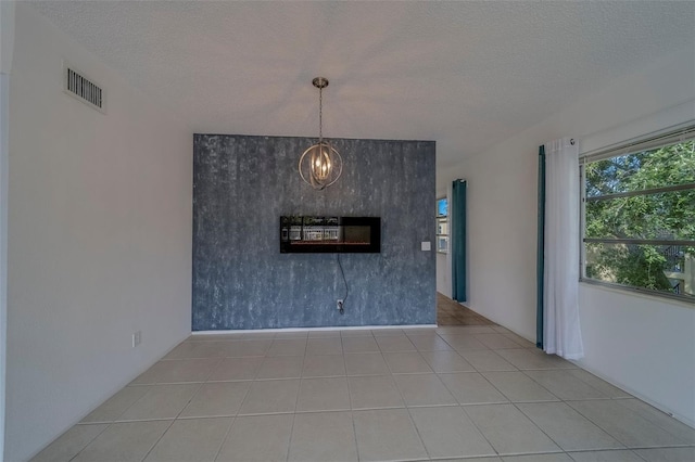 2441 Persian Dr Unit 61, Clearwater, FL 33763 - unfurnished living room featuring a textured ceiling and a chandelier