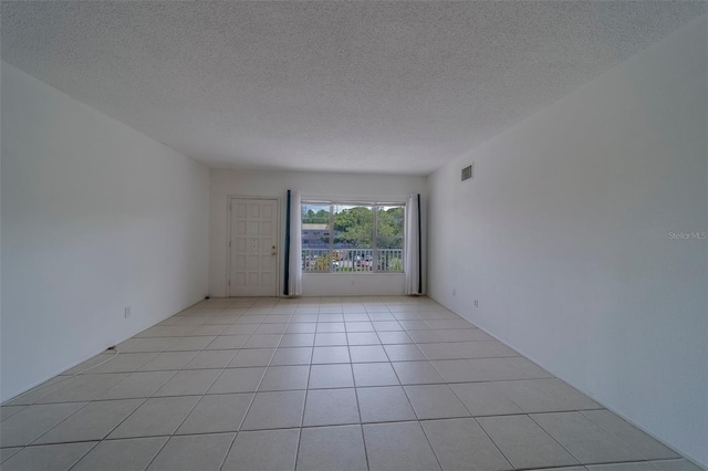 2441 Persian Dr Unit 61, Clearwater, FL 33763 - spare room with a textured ceiling and light tile patterned flooring