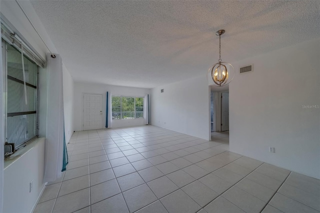 2441 Persian Dr Unit 61, Clearwater, FL 33763 - unfurnished room with a chandelier, a textured ceiling, and light tile patterned floors