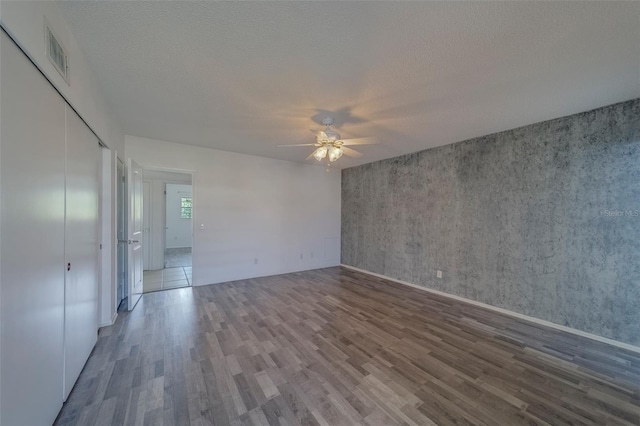 2441 Persian Dr Unit 61, Clearwater, FL 33763 - spare room featuring wood finished floors, ceiling fan, a textured ceiling, and baseboards