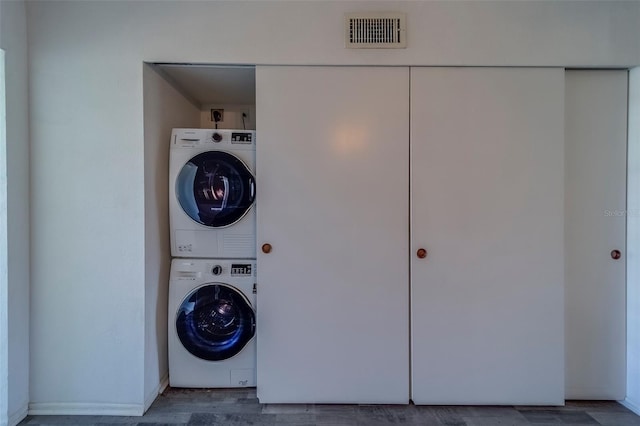 2441 Persian Dr Unit 61, Clearwater, FL 33763 - laundry area with stacked washer / drying machine and baseboards