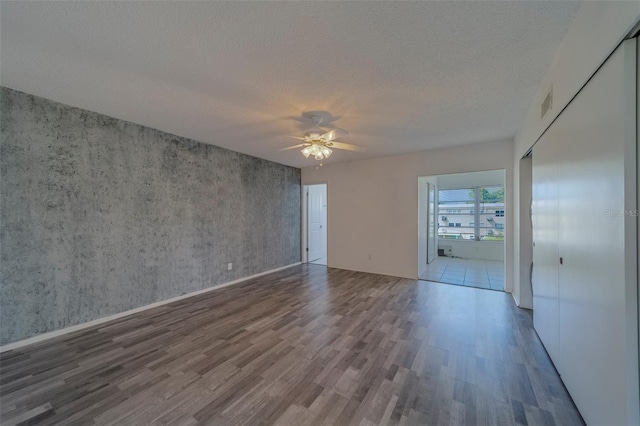 2441 Persian Dr Unit 61, Clearwater, FL 33763 - unfurnished room featuring wood finished floors, ceiling fan, and a textured ceiling