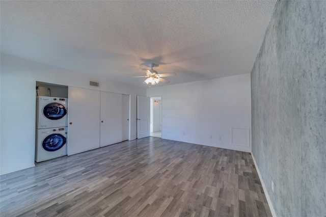 2441 Persian Dr Unit 61, Clearwater, FL 33763 - unfurnished bedroom featuring stacked washing machine and dryer, wood finished floors, a textured ceiling, a ceiling fan, and a closet