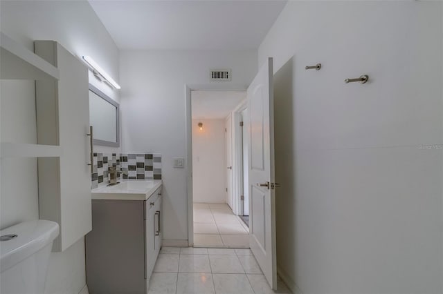 2441 Persian Dr Unit 61, Clearwater, FL 33763 - bathroom with vanity, toilet, and tasteful backsplash