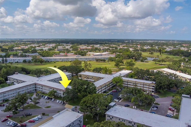 2441 Persian Dr Unit 61, Clearwater, FL 33763 - drone / aerial view of a golf course, a nearby body of water, and apartment complex