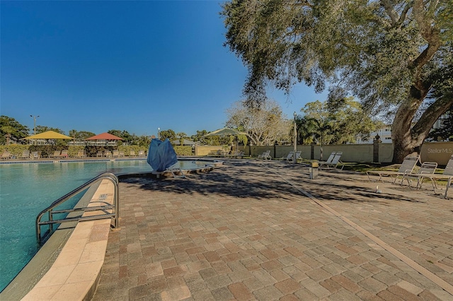 2441 Persian Dr Unit 61, Clearwater, FL 33763 - dock featuring a community pool and a patio