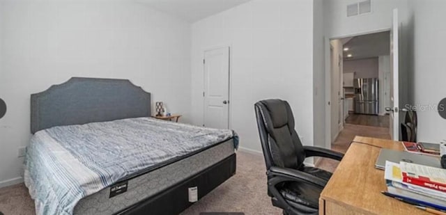 10448 Ladybug Cv, Parrish, FL 34219 - carpeted bedroom with stainless steel refrigerator with ice dispenser, a desk, lofted ceiling, and baseboards