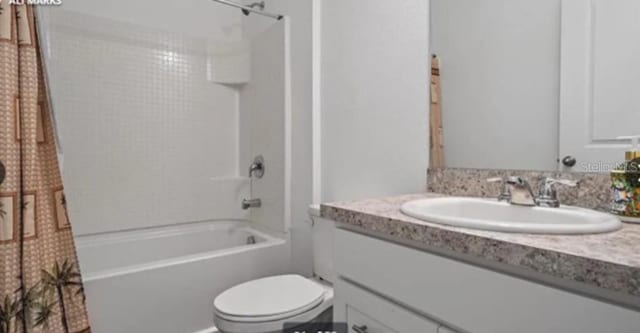 10448 Ladybug Cv, Parrish, FL 34219 - full bathroom with vanity, toilet, and shower / bathtub combination with curtain