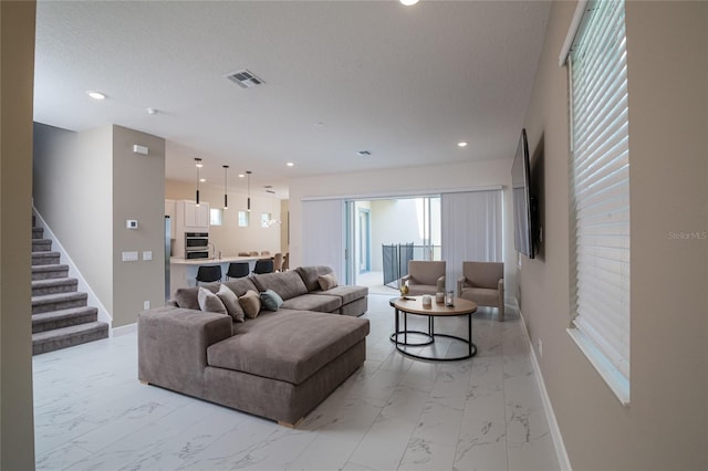 1430 Reunion Blvd, Reunion, FL 34747 - living room featuring light marble finish flooring, baseboards, stairway, and recessed lighting