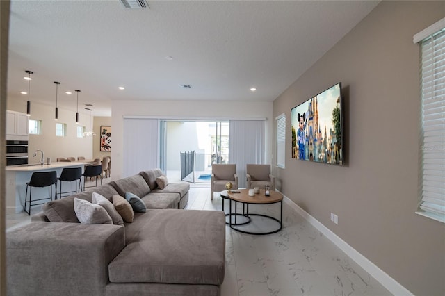 1430 Reunion Blvd, Reunion, FL 34747 - living room with light marble finish flooring, baseboards, recessed lighting, and plenty of natural light