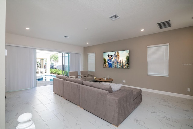1430 Reunion Blvd, Reunion, FL 34747 - living area with light marble finish floors, recessed lighting, and baseboards
