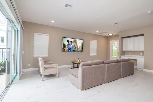 1430 Reunion Blvd, Reunion, FL 34747 - living room with light marble finish floors, recessed lighting, and baseboards