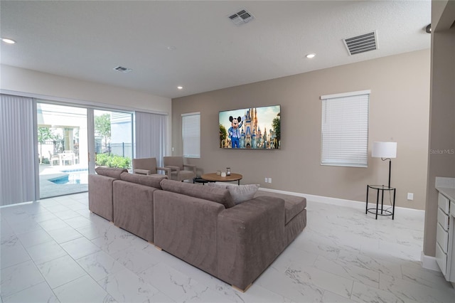 1430 Reunion Blvd, Reunion, FL 34747 - living area with light marble finish flooring, baseboards, and recessed lighting