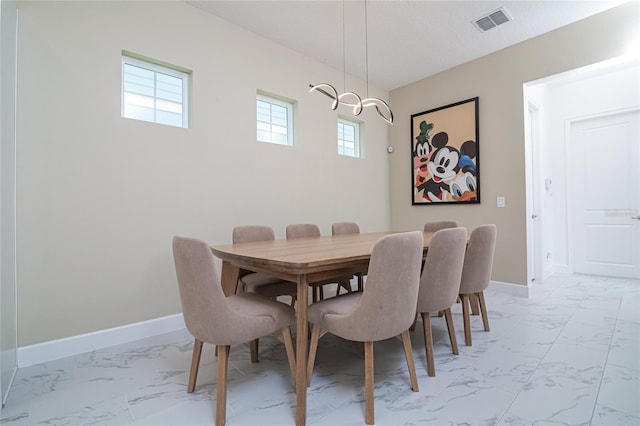1430 Reunion Blvd, Reunion, FL 34747 - dining room featuring light marble finish flooring, a chandelier, baseboards, and healthy amount of natural light