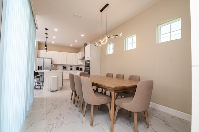 1430 Reunion Blvd, Reunion, FL 34747 - dining space with light marble finish flooring, recessed lighting, and baseboards