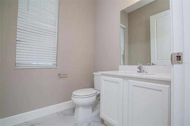 1430 Reunion Blvd, Reunion, FL 34747 - half bathroom featuring marble look tiles, toilet, vanity, and baseboards