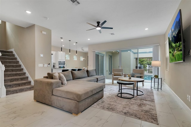 1430 Reunion Blvd, Reunion, FL 34747 - living room featuring light marble finish floors, a ceiling fan, stairs, baseboards, and recessed lighting