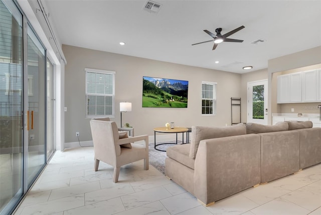 1430 Reunion Blvd, Reunion, FL 34747 - living room with light marble finish flooring, a ceiling fan, recessed lighting, and baseboards