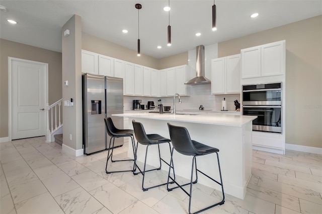 1430 Reunion Blvd, Reunion, FL 34747 - kitchen featuring wall chimney range hood, stainless steel appliances, light marble finish flooring, light countertops, and a kitchen bar