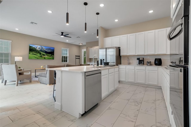 1430 Reunion Blvd, Reunion, FL 34747 - kitchen with appliances with stainless steel finishes, open floor plan, a sink, light marble finish floors, and ceiling fan