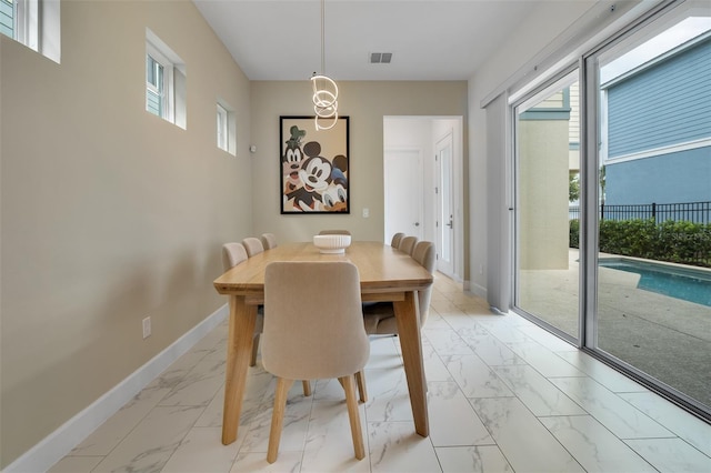 1430 Reunion Blvd, Reunion, FL 34747 - dining space featuring light marble finish floors and baseboards